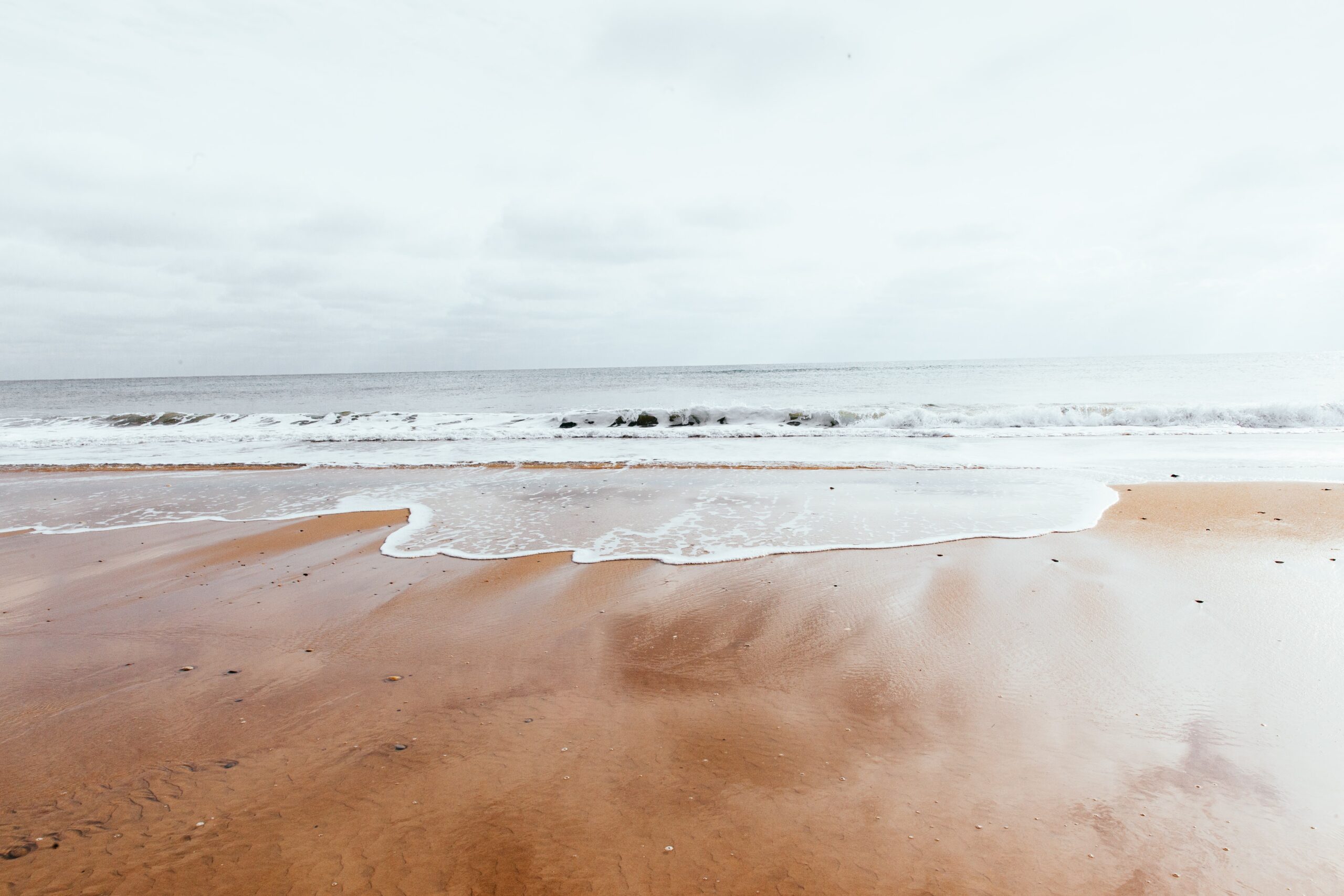 Waves on sand at a beach 