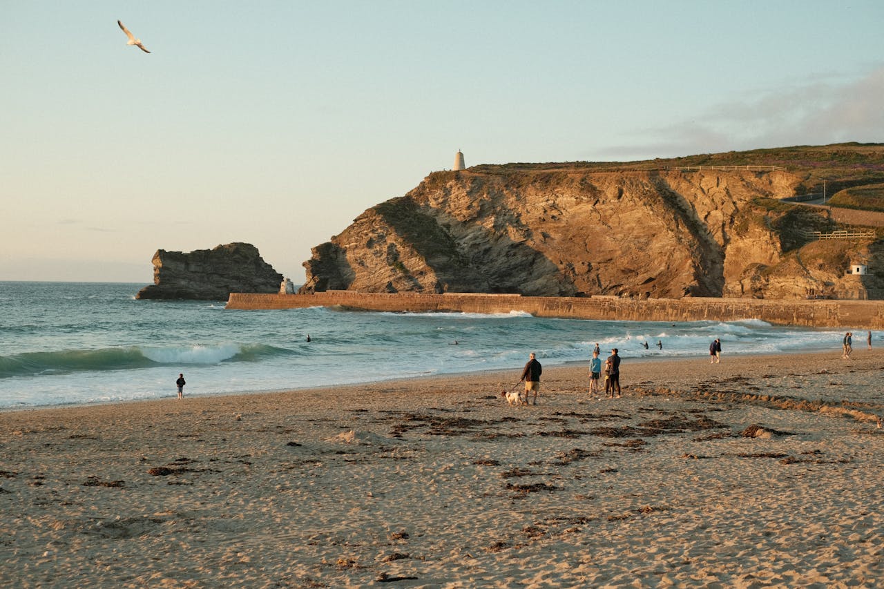 Families enjoying a beach in Cornwall during sunset