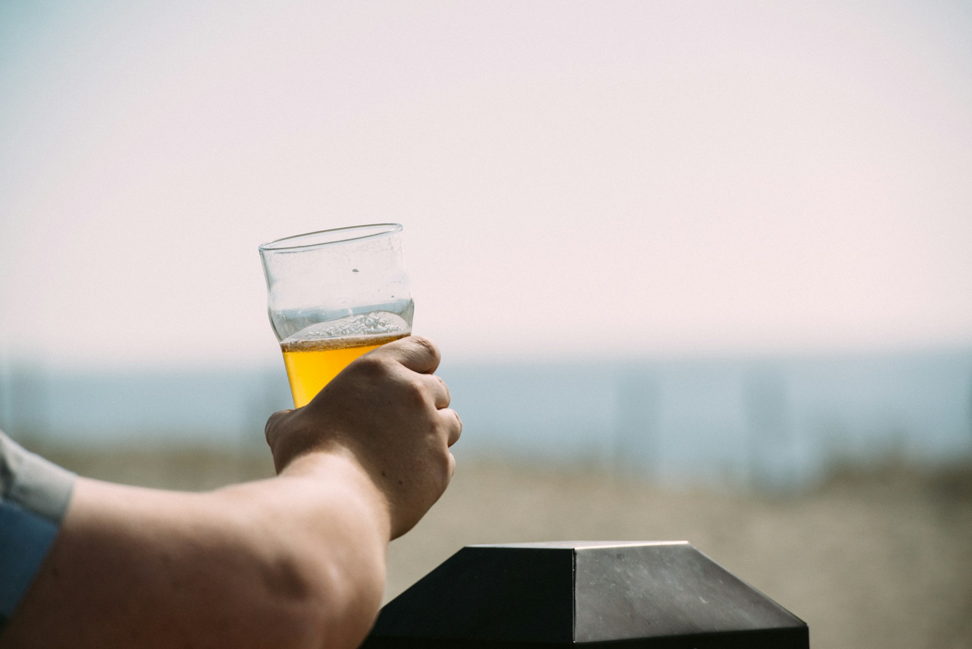 Someone enjoying a beer during a pub crawl in Cornwall