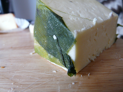 A slice of Cornish Yarg cheese on a table
