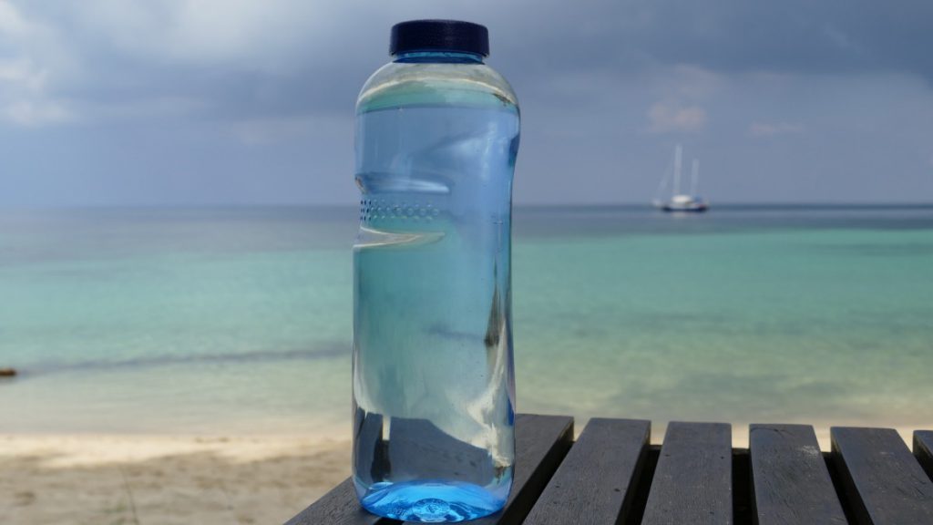 bottle of water on a table at the beach