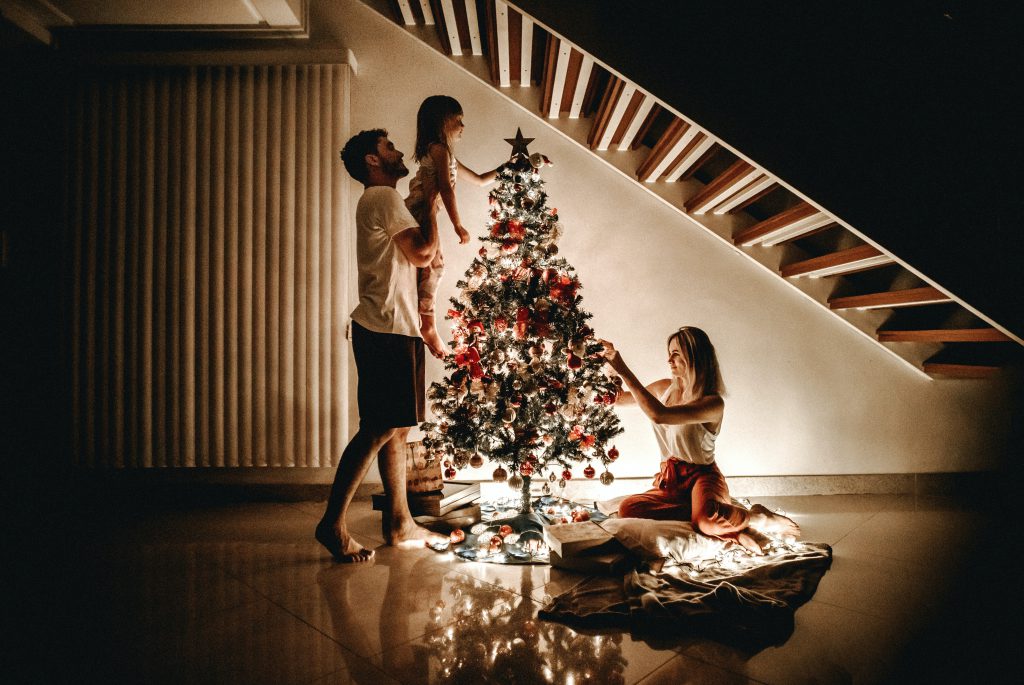 A family decorating a Christmas tree