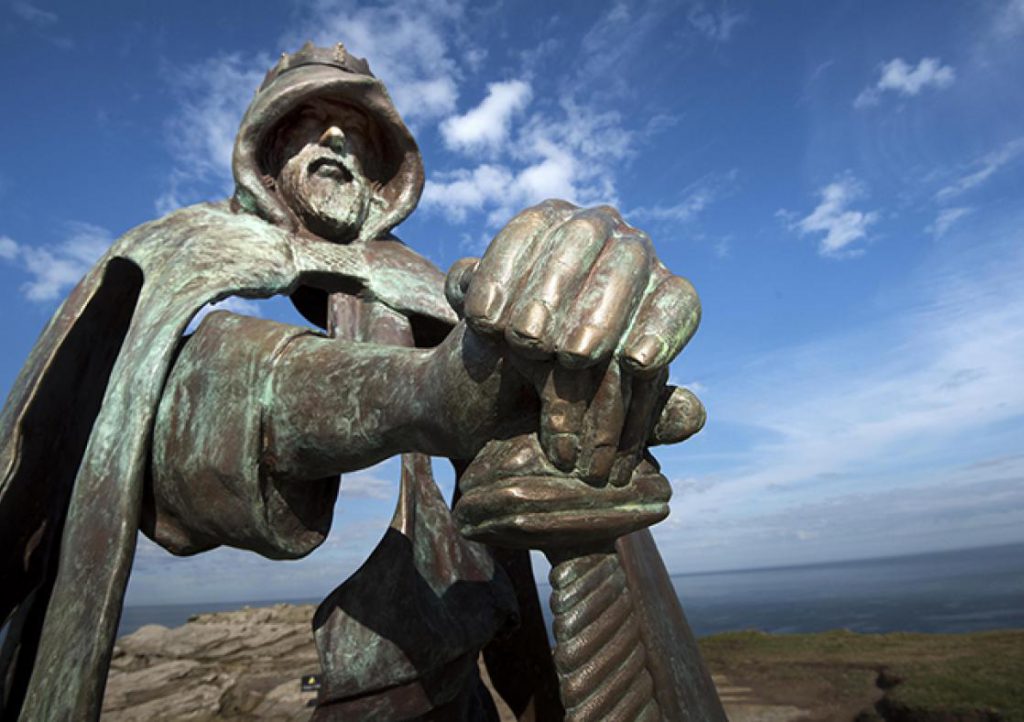 Bronze statue of Gallos at Tintagel castle
