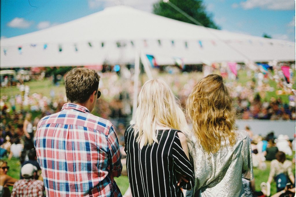 Three people at a festival 