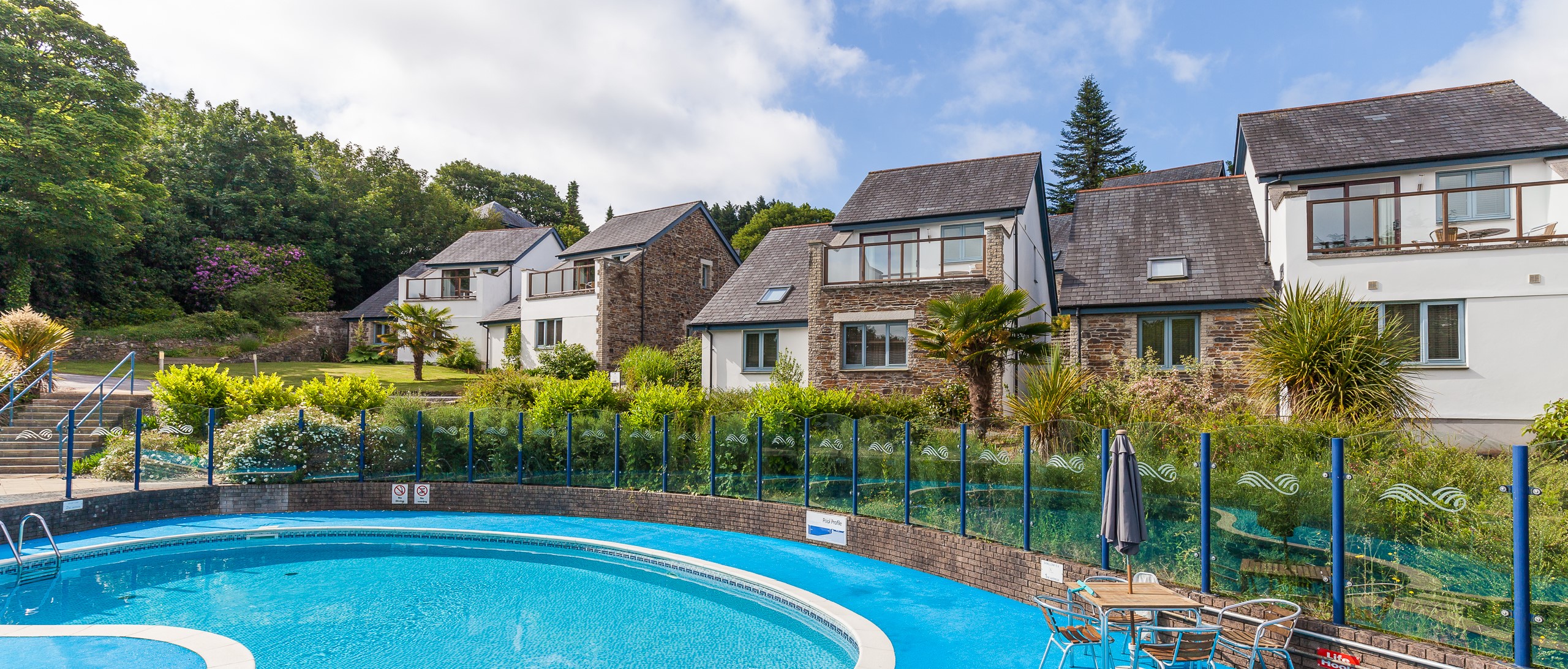 The Valley’s outdoor pool with cottages in Truro, Cornwall
